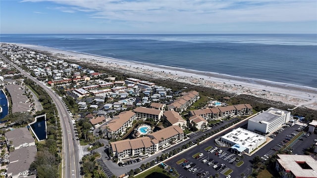 birds eye view of property with a water view and a beach view