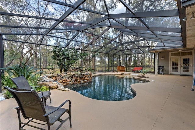 outdoor pool featuring a patio, french doors, and a lanai