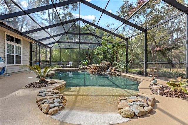 outdoor pool with a patio area and a lanai