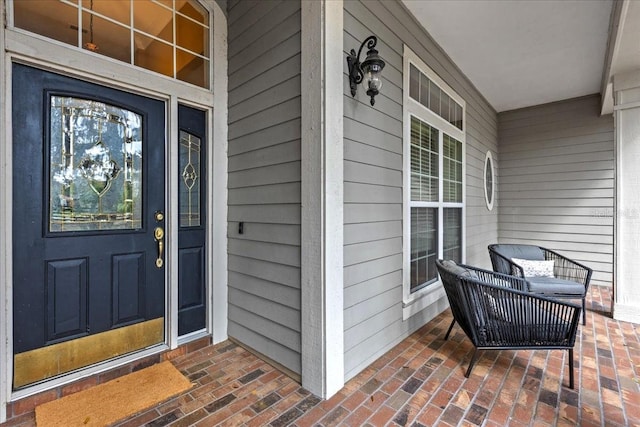 view of exterior entry featuring covered porch