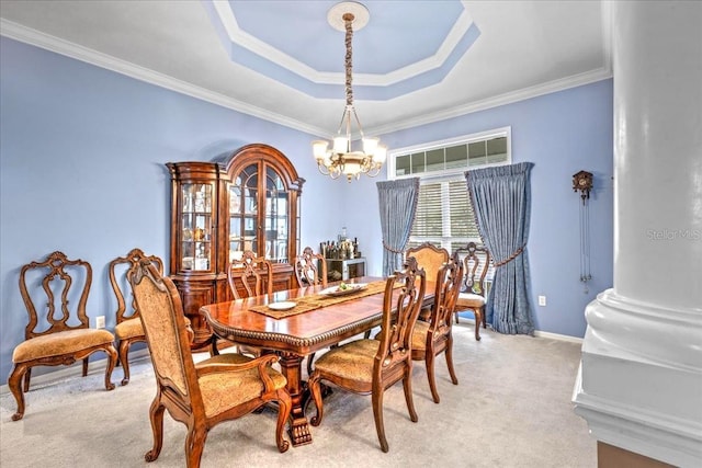 dining area with a notable chandelier, a raised ceiling, light colored carpet, ornamental molding, and baseboards