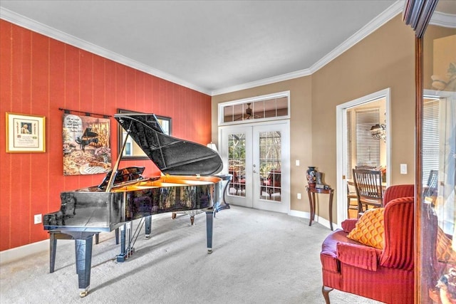 sitting room with carpet, french doors, crown molding, and baseboards