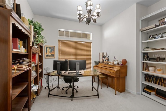 carpeted home office featuring baseboards and a chandelier