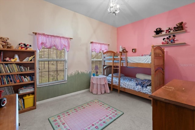 carpeted bedroom featuring a notable chandelier