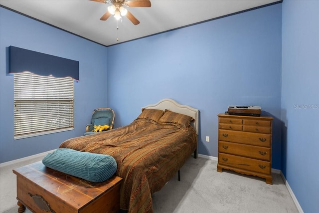 carpeted bedroom featuring baseboards and a ceiling fan