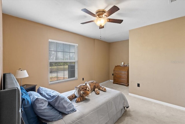 bedroom featuring light colored carpet, ceiling fan, and baseboards