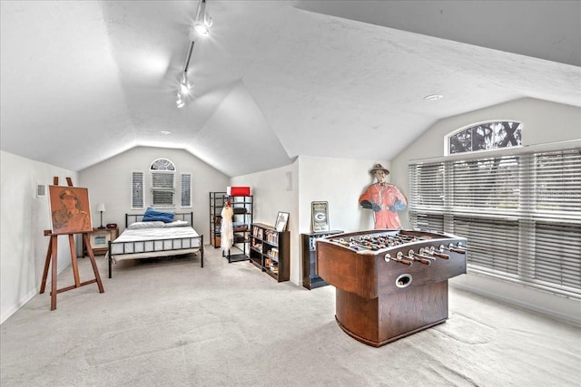 game room with lofted ceiling, carpet, and track lighting