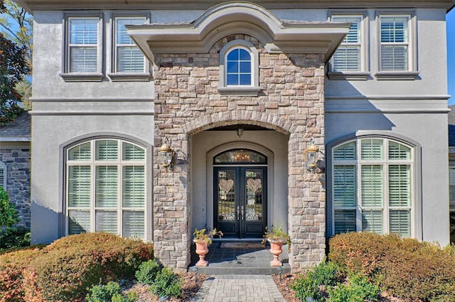 doorway to property with stucco siding and french doors