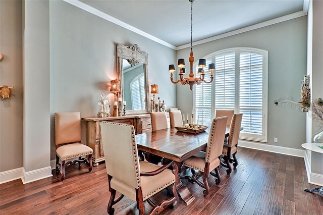 dining room with dark wood-style floors, ornamental molding, baseboards, and an inviting chandelier