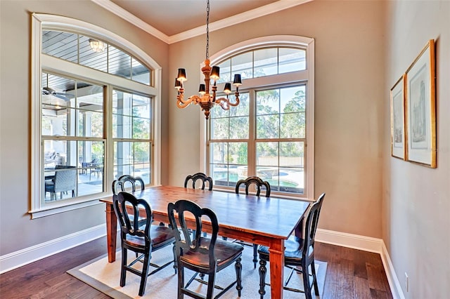 dining area featuring an inviting chandelier, baseboards, ornamental molding, and dark wood finished floors