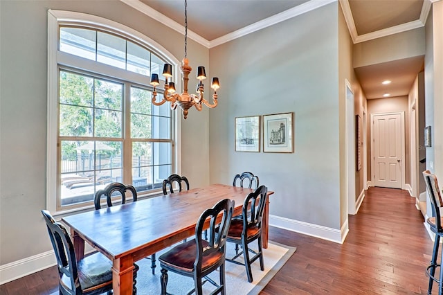 dining space with an inviting chandelier, crown molding, baseboards, and dark wood-type flooring