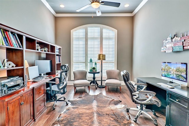 home office featuring crown molding, plenty of natural light, and wood finished floors