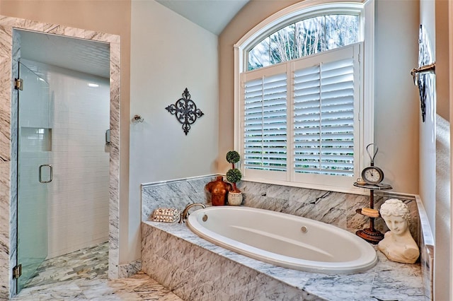 bathroom with a shower stall and a bath