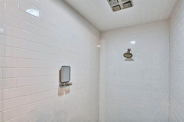 bathroom with a tile shower