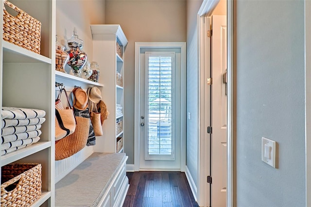 mudroom with dark wood-style flooring and baseboards