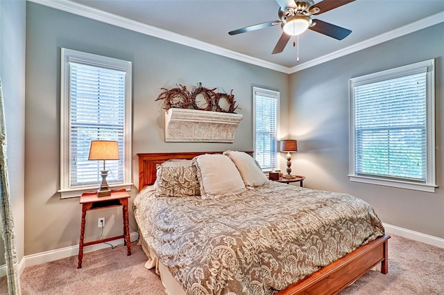 carpeted bedroom featuring ornamental molding, multiple windows, and baseboards