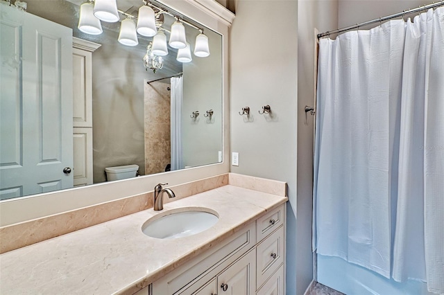 bathroom featuring toilet and vanity