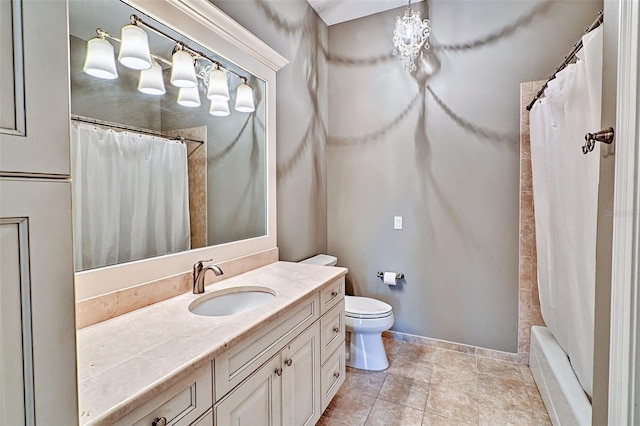 bathroom with tile patterned floors, vanity, toilet, and baseboards