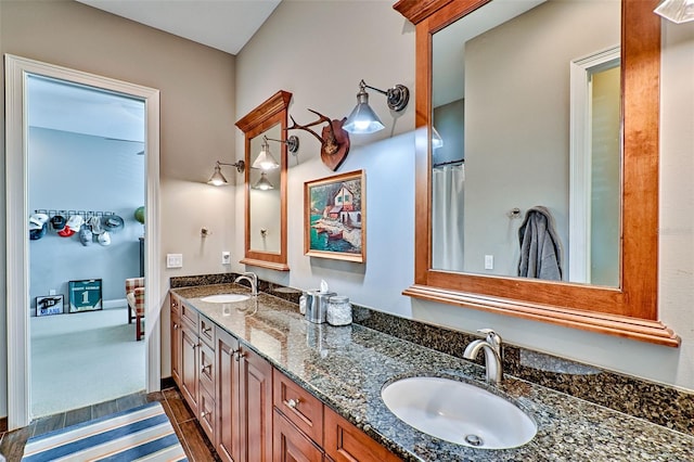 full bath featuring double vanity and a sink