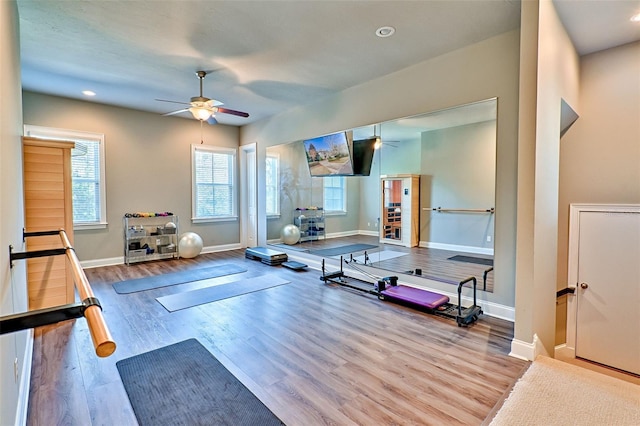 workout area featuring ceiling fan, baseboards, wood finished floors, and recessed lighting