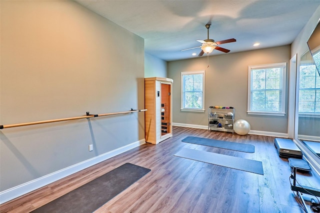 exercise room featuring recessed lighting, wood finished floors, a ceiling fan, and baseboards