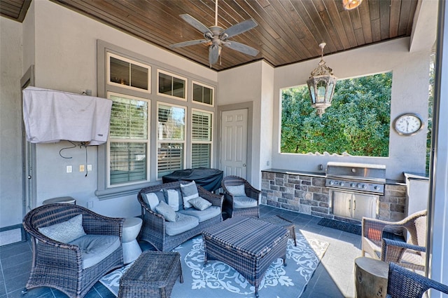 view of patio with ceiling fan, an outdoor kitchen, area for grilling, and an outdoor living space