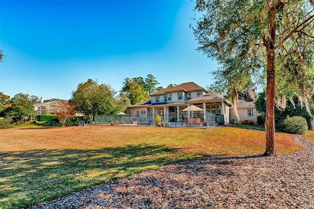 view of front of house with a front lawn and fence