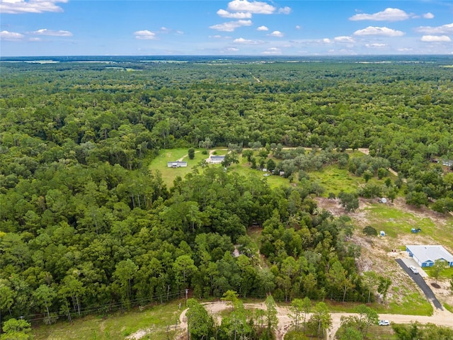 bird's eye view featuring a wooded view