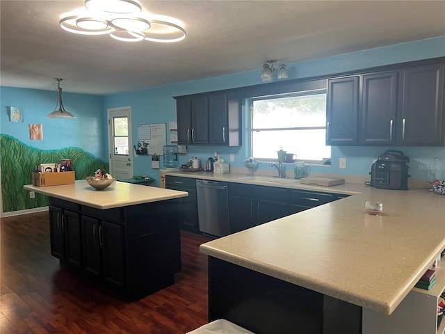 kitchen with a wealth of natural light, dishwasher, light countertops, and a sink