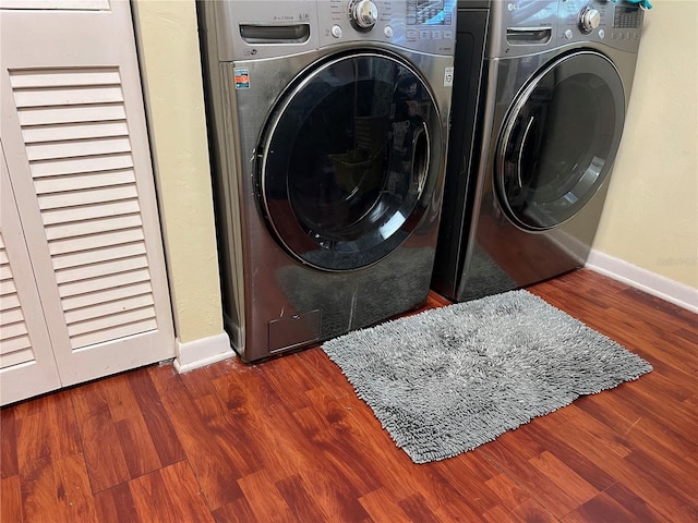 washroom featuring laundry area, baseboards, and wood finished floors