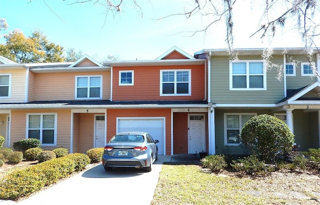 townhome / multi-family property featuring driveway