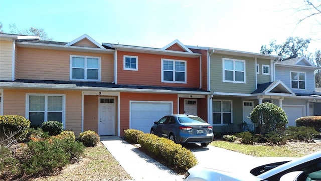 townhome / multi-family property with an attached garage and driveway