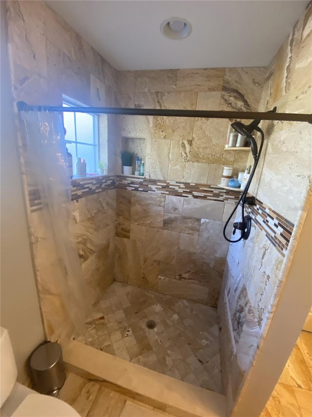 full bath featuring toilet and a stall shower