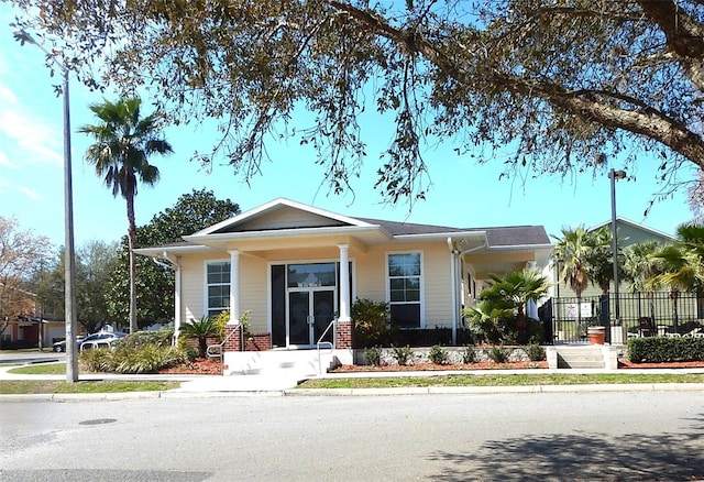 view of front of home featuring fence