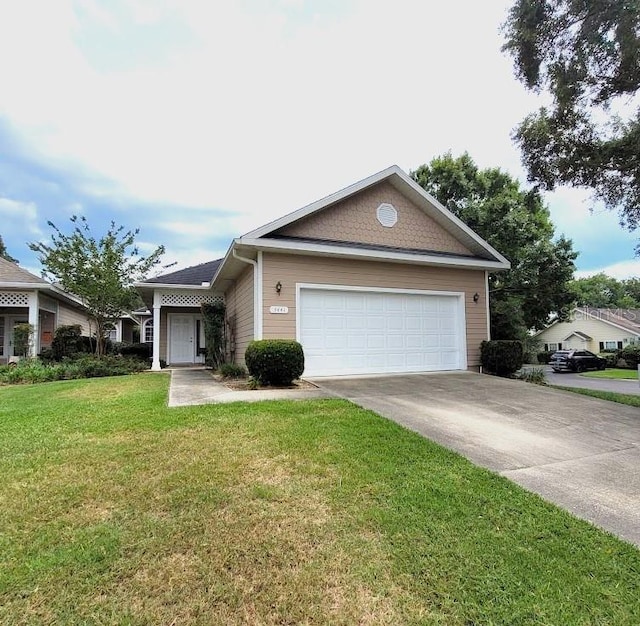 single story home featuring a garage, concrete driveway, and a front lawn