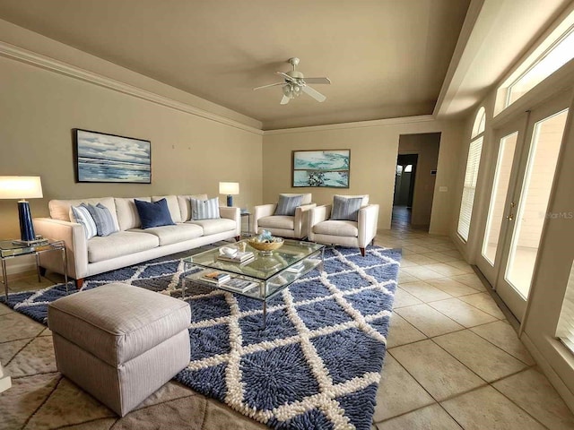 living area with ornamental molding, french doors, light tile patterned flooring, and a ceiling fan