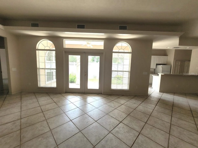 doorway to outside with french doors, light tile patterned flooring, and visible vents