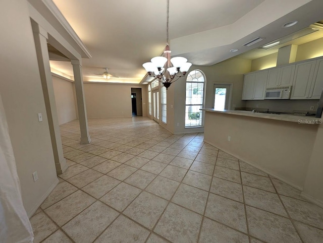 3441 NW 104th Way, Gainesville, FL 32606 - unfurnished dining area with visible vents, light tile patterned floors, baseboards, ceiling fan with notable chandelier, and ornate columns