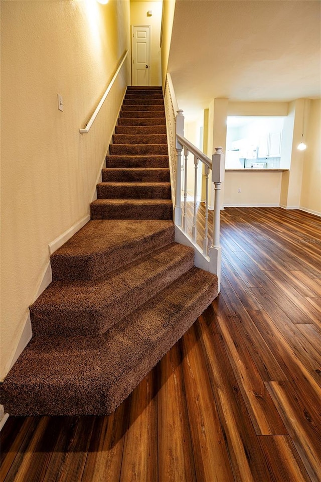 stairs with wood finished floors