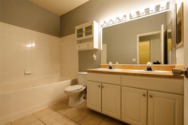 bathroom with tile patterned flooring, a sink, toilet, and double vanity