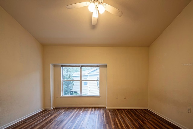 unfurnished room with dark wood-style floors, baseboards, and a ceiling fan