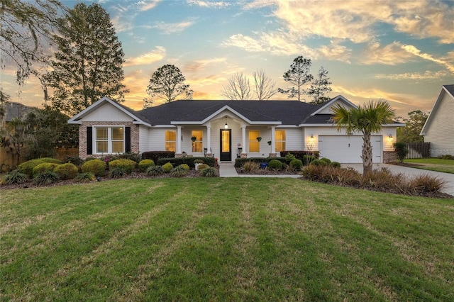 ranch-style home with fence, an attached garage, a front lawn, concrete driveway, and brick siding