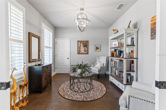 sitting room with visible vents, an inviting chandelier, and dark wood-style flooring