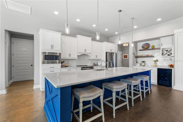 kitchen featuring dark wood-type flooring, a sink, open shelves, wine cooler, and appliances with stainless steel finishes