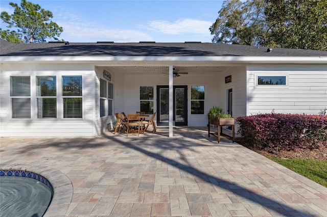 rear view of property featuring a patio, ceiling fan, and outdoor dining space