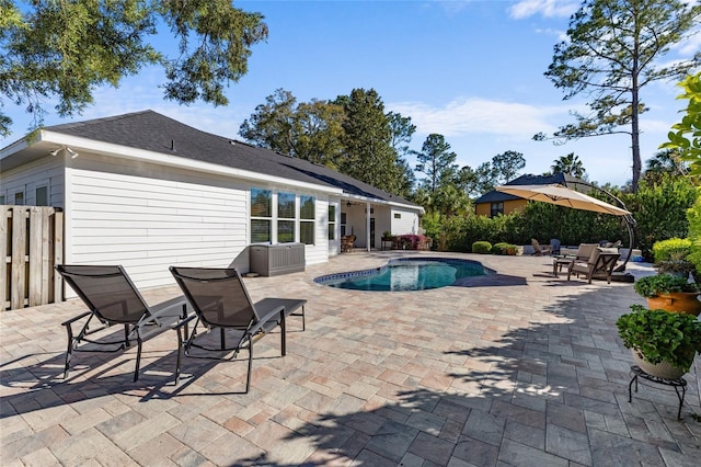 outdoor pool with a patio area and fence