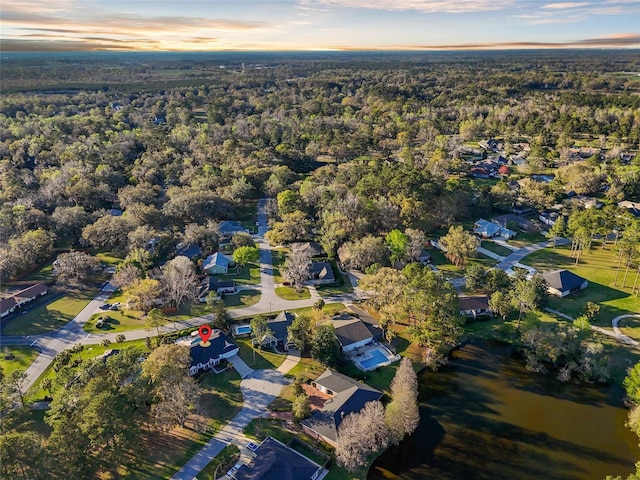 drone / aerial view with a forest view and a residential view