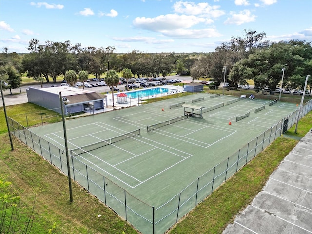 view of tennis court featuring fence