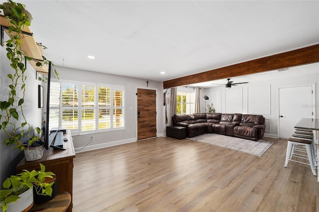 living room featuring light wood-style floors, recessed lighting, visible vents, and baseboards