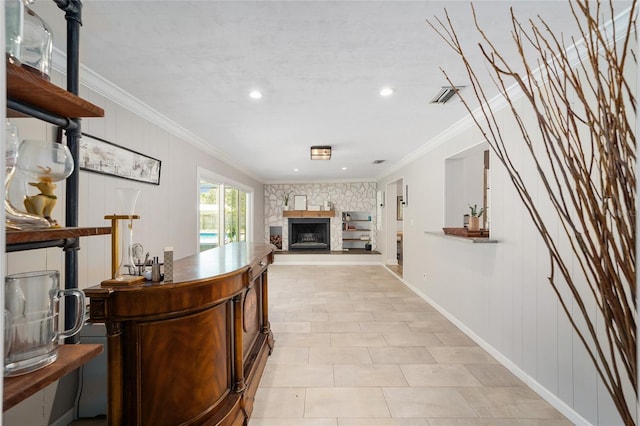 interior space featuring visible vents, crown molding, and baseboards